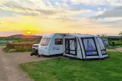 Electric hardstanding pitch with awning and countryside views Electric hardstanding pitch with awning and countryside views