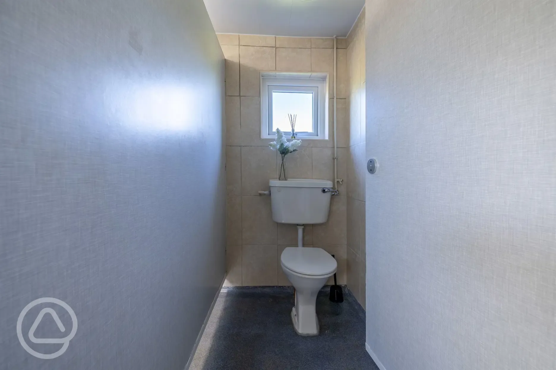 Toilet in the other facility building 