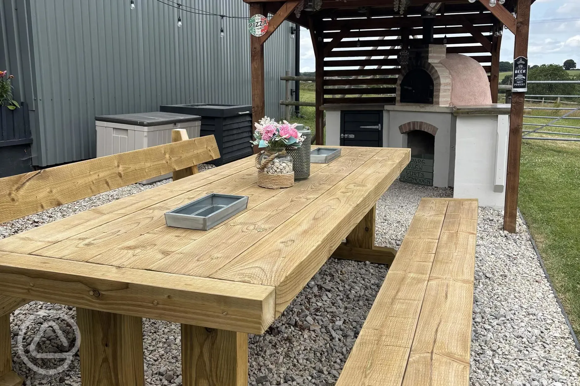 Communal kitchen and dining area outdoor seating and pizza oven