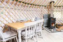 Silver Birch yurt dining area and wood-burning stove