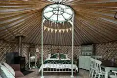 Horse Chestnut yurt interior with a king size bed and double sofa bed