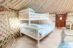 Mighty Oak yurt triple bunk bed and clothes rail with hangers