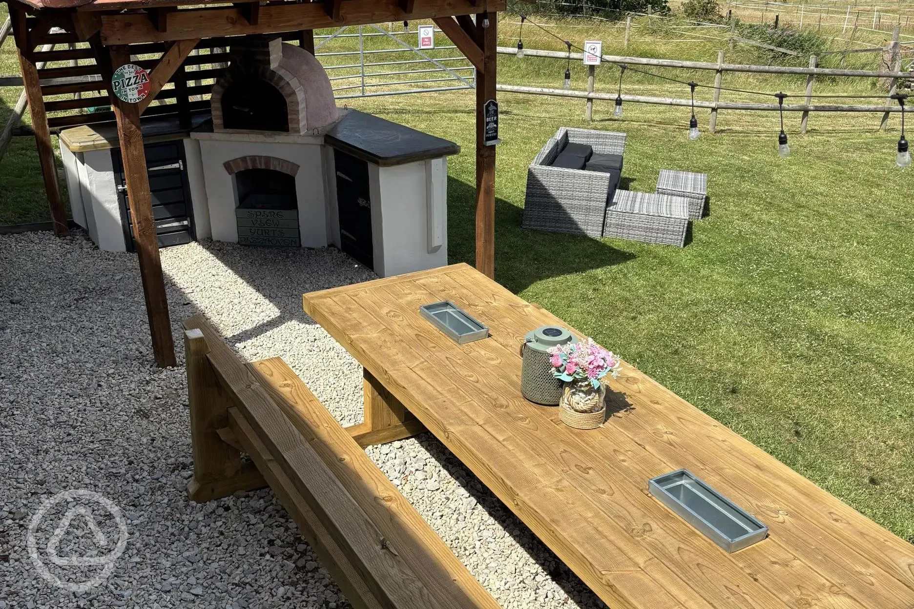 Communal kitchen and dining area outdoor seating and pizza oven