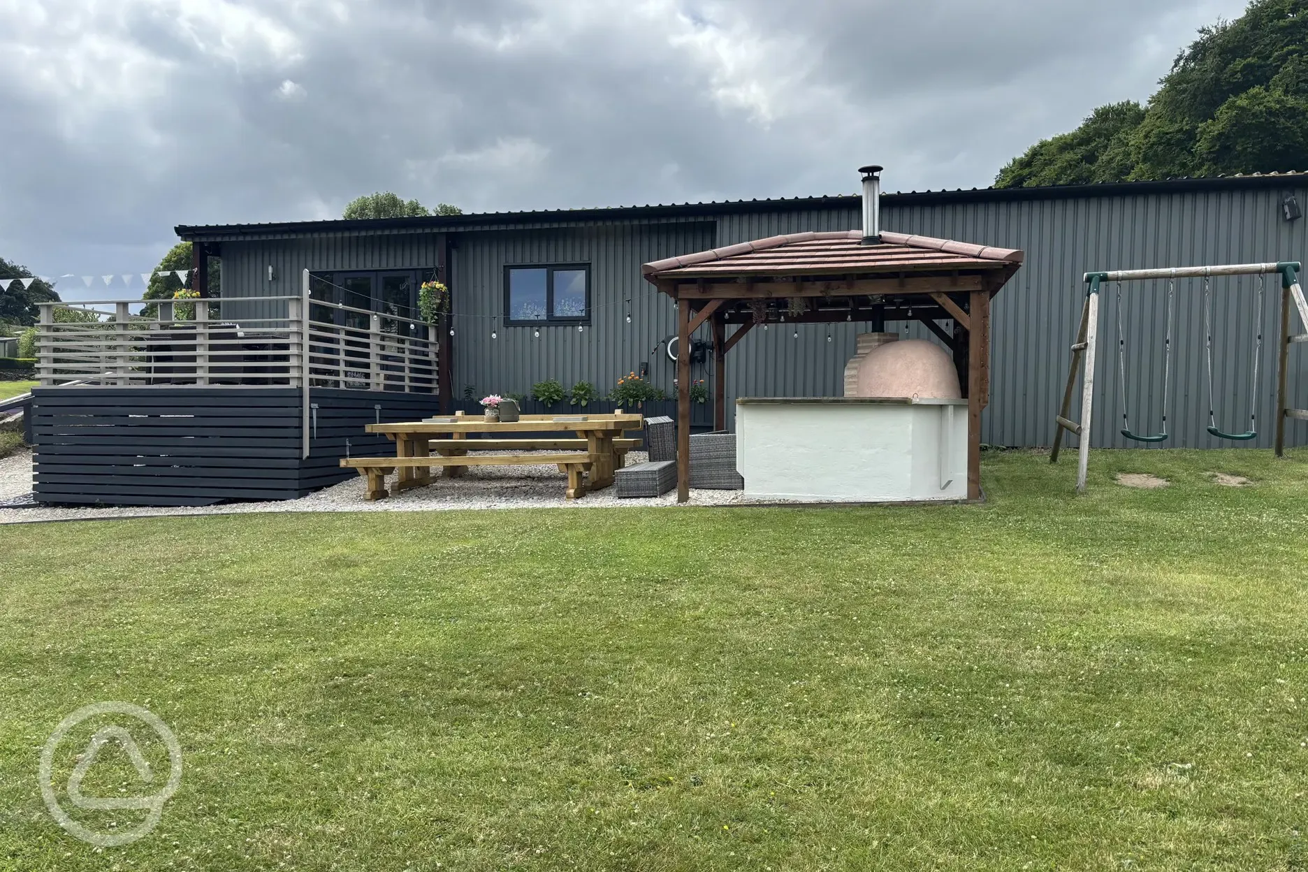 Communal kitchen and dining area outdoor seating and pizza oven