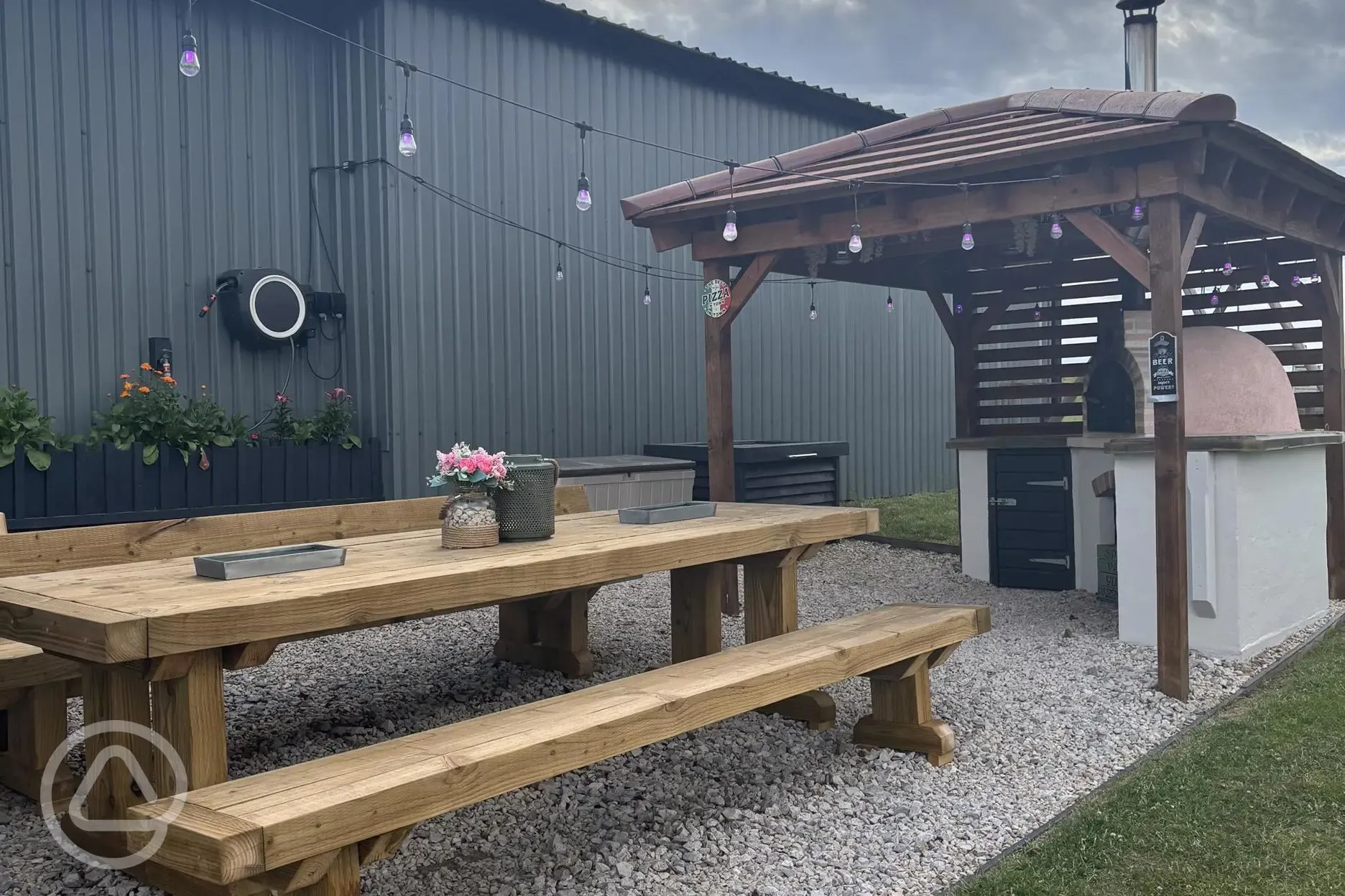 Communal kitchen and dining area outdoor seating and pizza oven