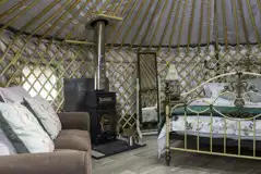 Horse Chestnut yurt interior with a wood-burning stove