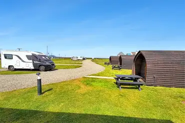 Electric hardstanding pitches beside the pods at Harbour Side Caravan Site