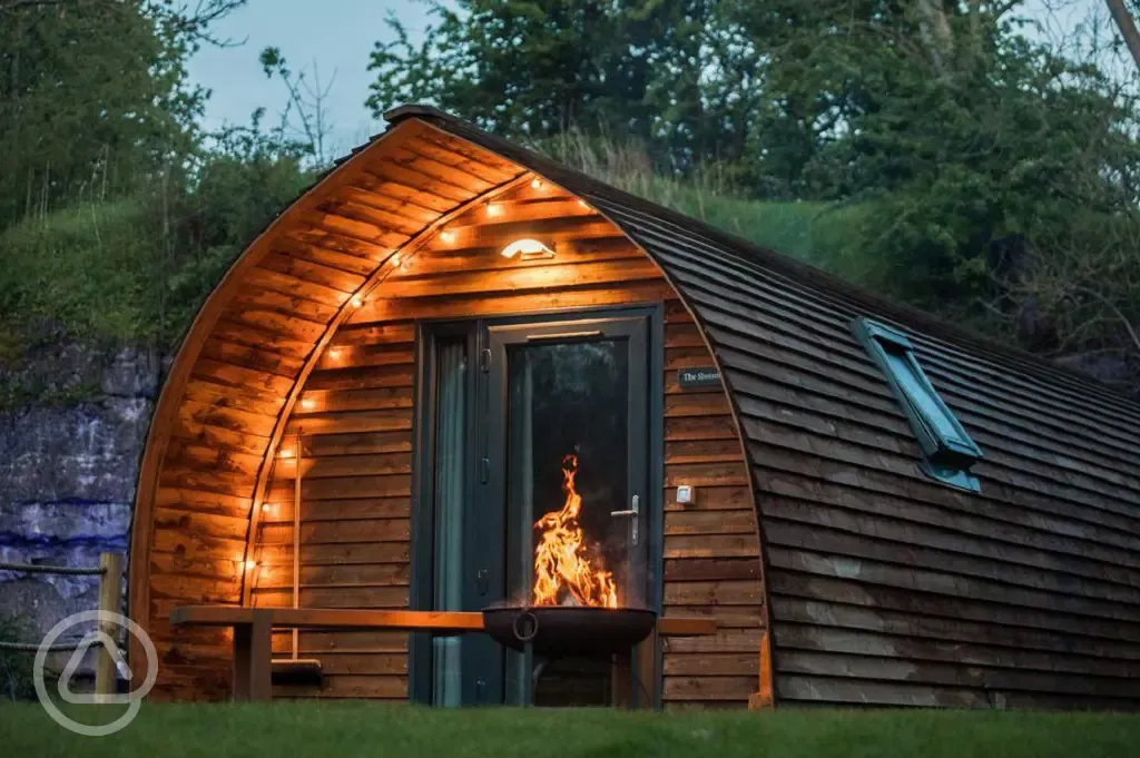 Ensuite deluxe Wigwam pod with hot tub at night