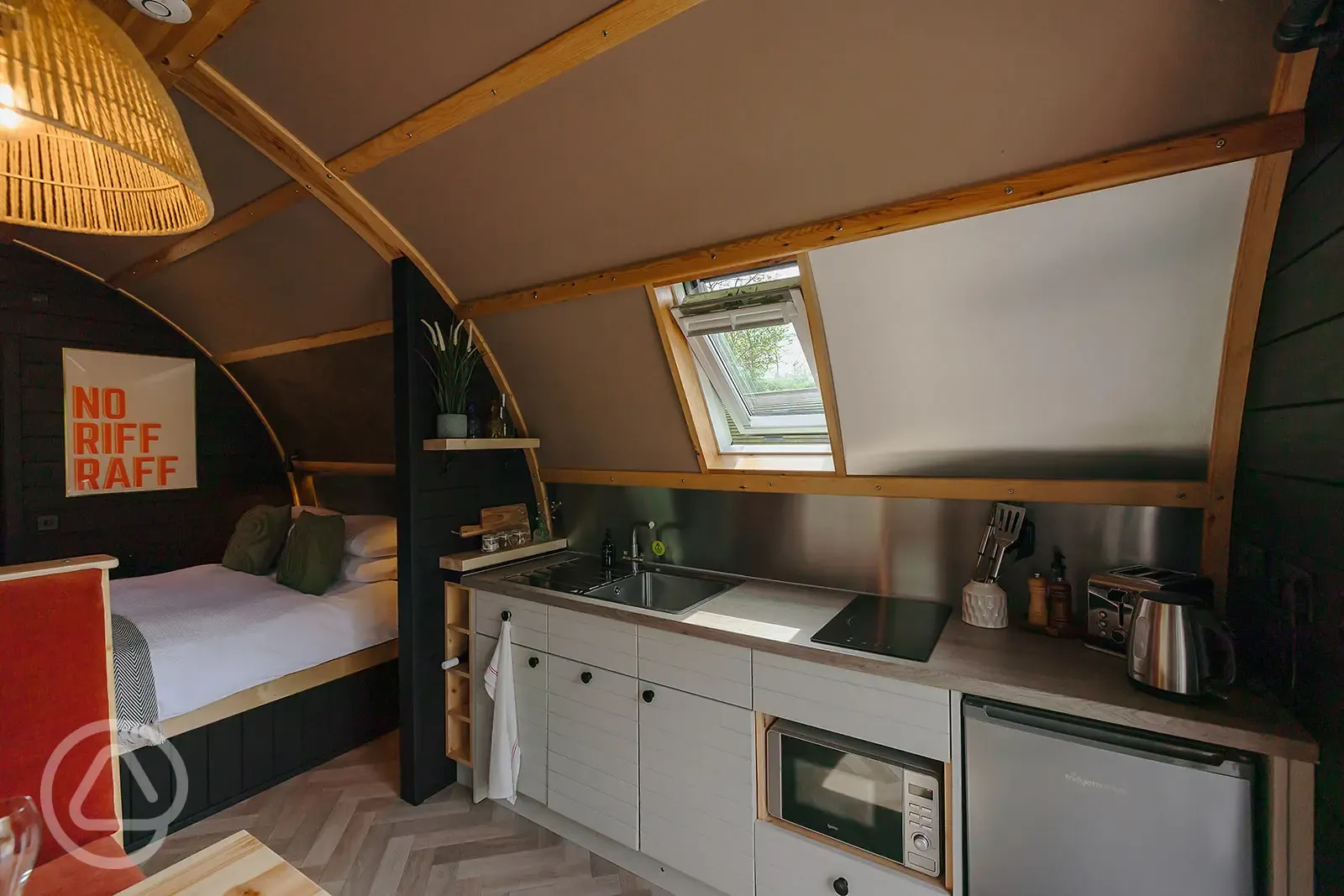 Quarry pod interior with kitchenette and double bed