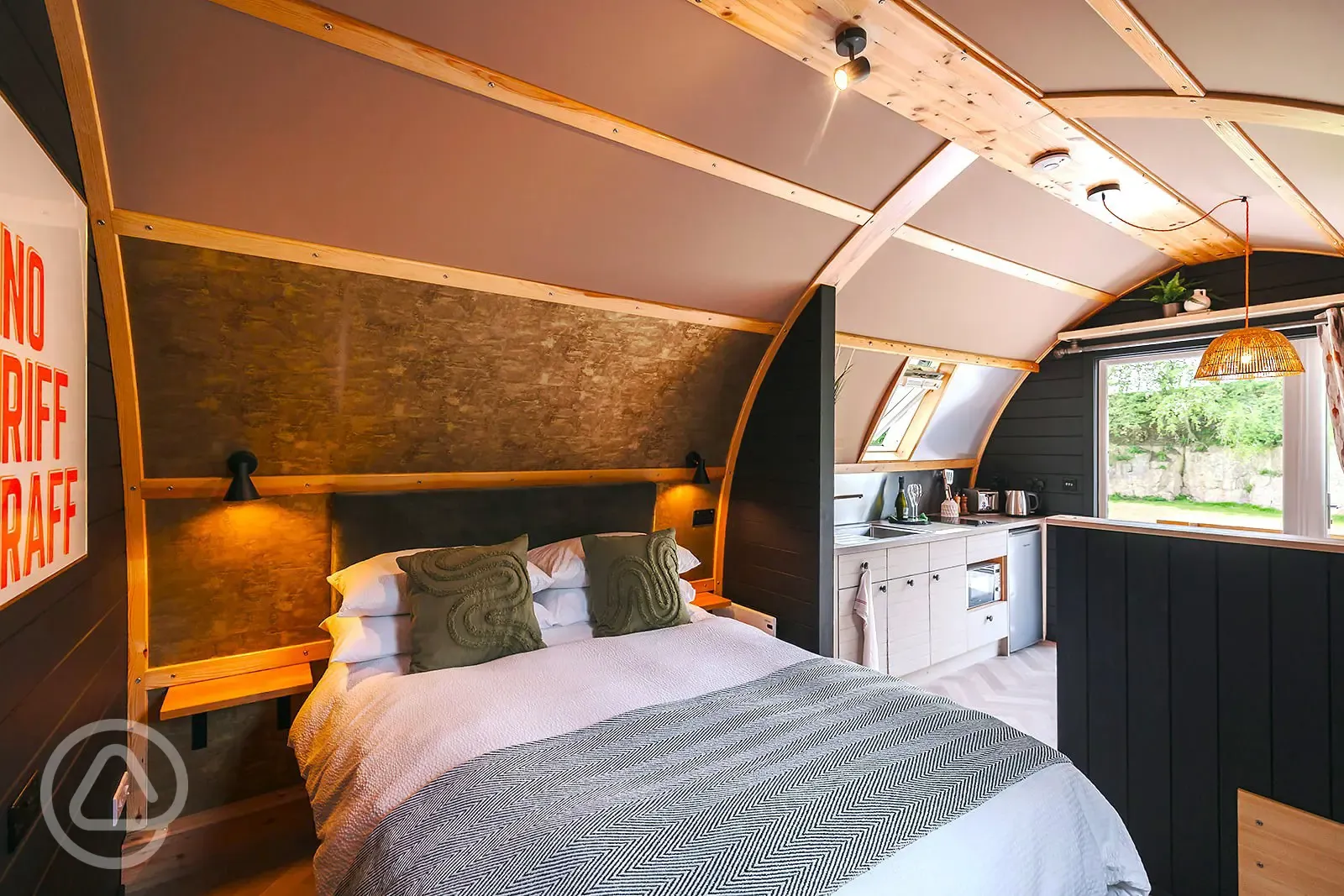 Quarry pod interior with double bed and kitchenette