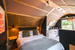 Quarry pod interior with double bed and kitchenette