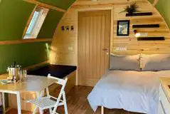 Foxwood pod interior with double bed and seating area