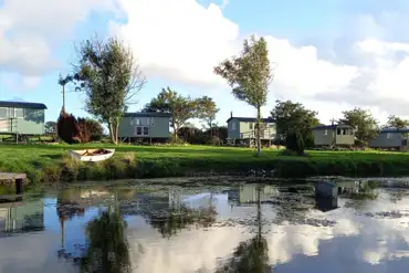 Shepherd's huts across the lake