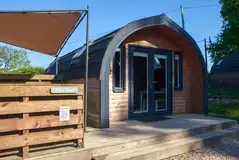 The Den glamping pod with a covered hot tub and decking The Den glamping pod with a covered hot tub and decking