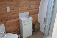 The Den and Roost glamping pod ensuite with shower, toilet and sink