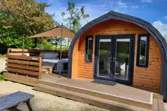 The Den glamping pod exterior with hot tub at Auchenhean Pods
