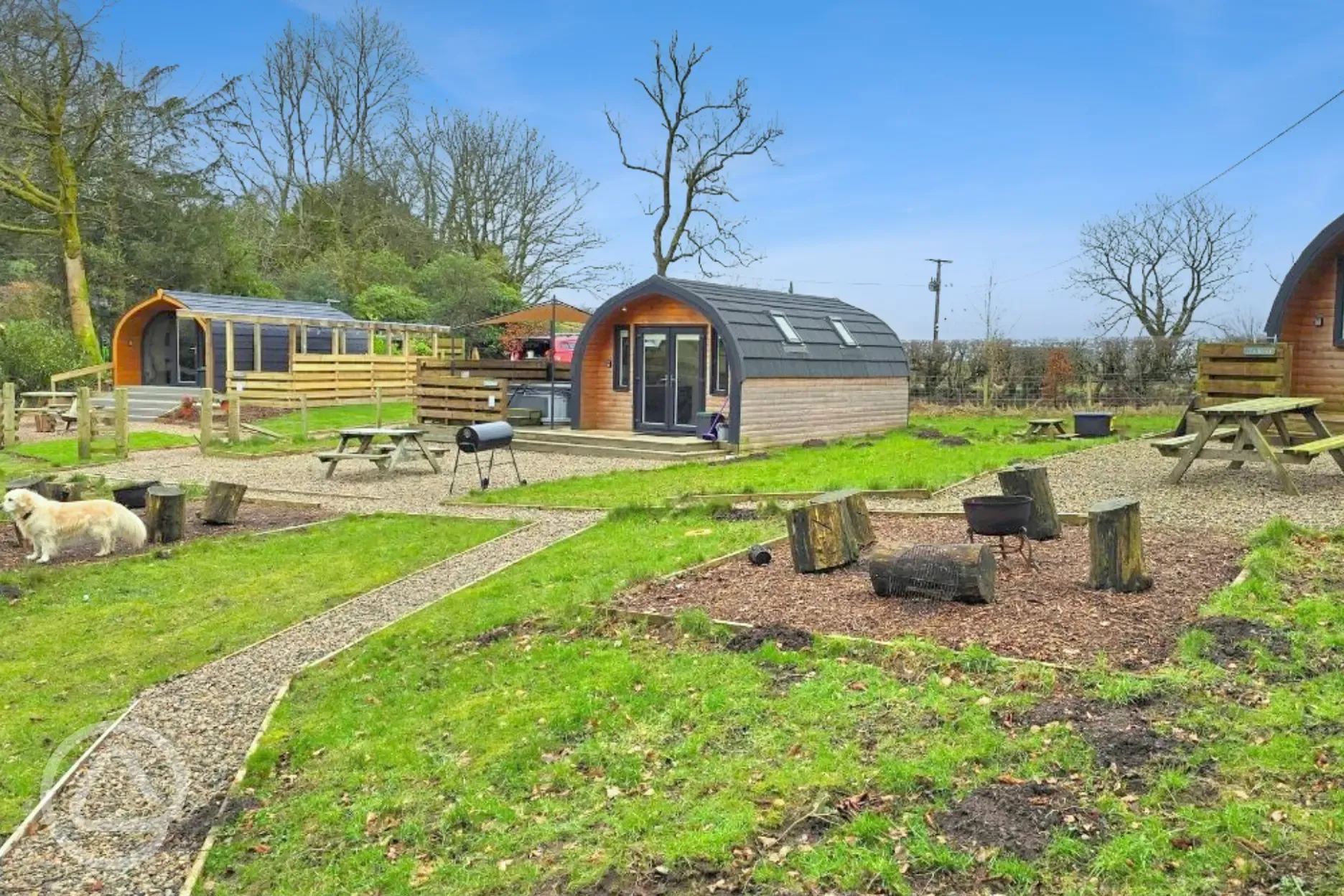 The Nest, Den and Roost glamping pod exteriors, all with private hot tubs