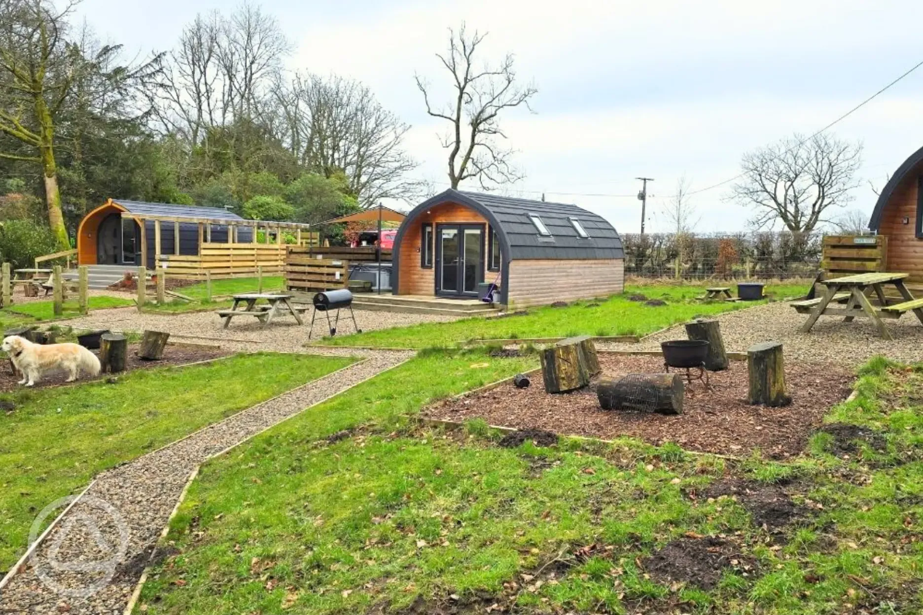 The Nest, Den and Roost glamping pod exteriors, all with private hot tubs