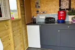 Dragonfly shepherd's hut outdoor kitchen with a kettle and cooking equipment
