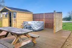 Carousel yurt with optional electric hot tub and outdoor kitchen cabin