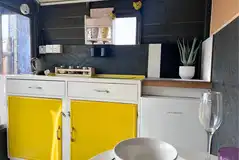 Bumble shepherd's hut indoor kitchen area with a fridge and kettle