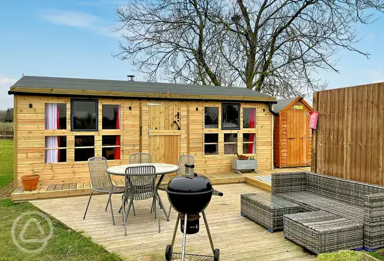 View of Winnie cabin with an optional wood-fired hot tub at Westerby Farm