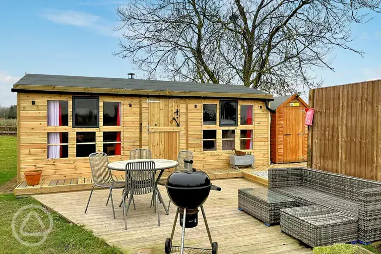 View of Winnie cabin with an optional wood-fired hot tub at Westerby Farm