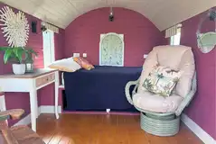 Dragonfly shepherd's hut interior with a double bed and furniture