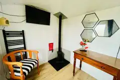 Fire place and smart TV in the Bumble shepherd's hut