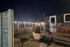 Bumble shepherd's hut with a hot tub at night Bumble shepherd's hut with a hot tub at night