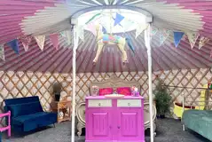 Carousel yurt with king sized bed, singles, and sofa beds