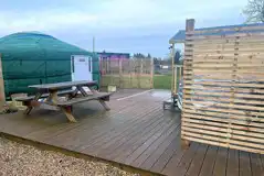 Carousel yurt exterior with outdoor decking and a picnic bench