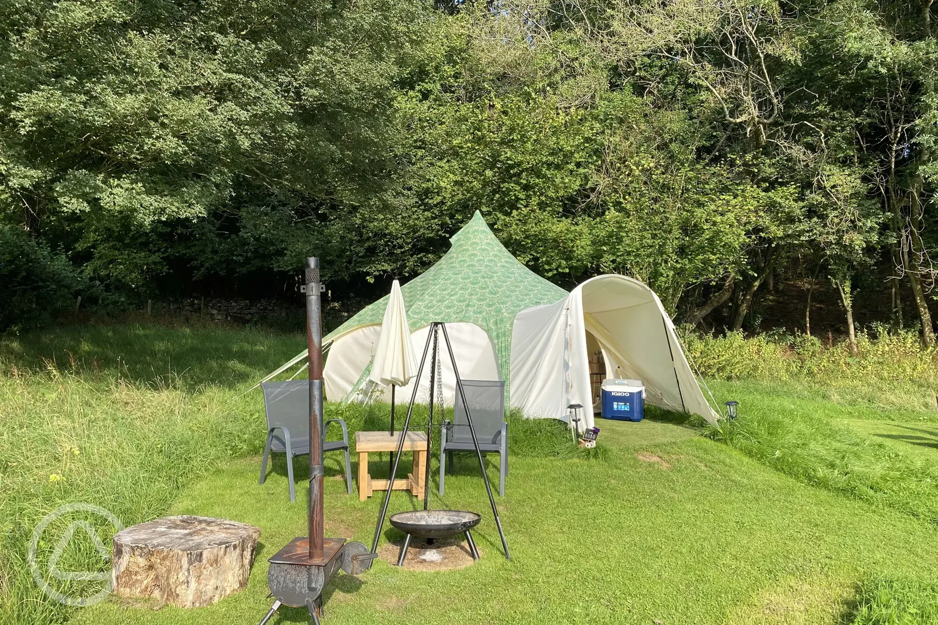 Bell tent with private outdoor seating and a fire pit