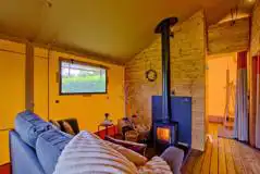 Safari tent living area with a wood burner