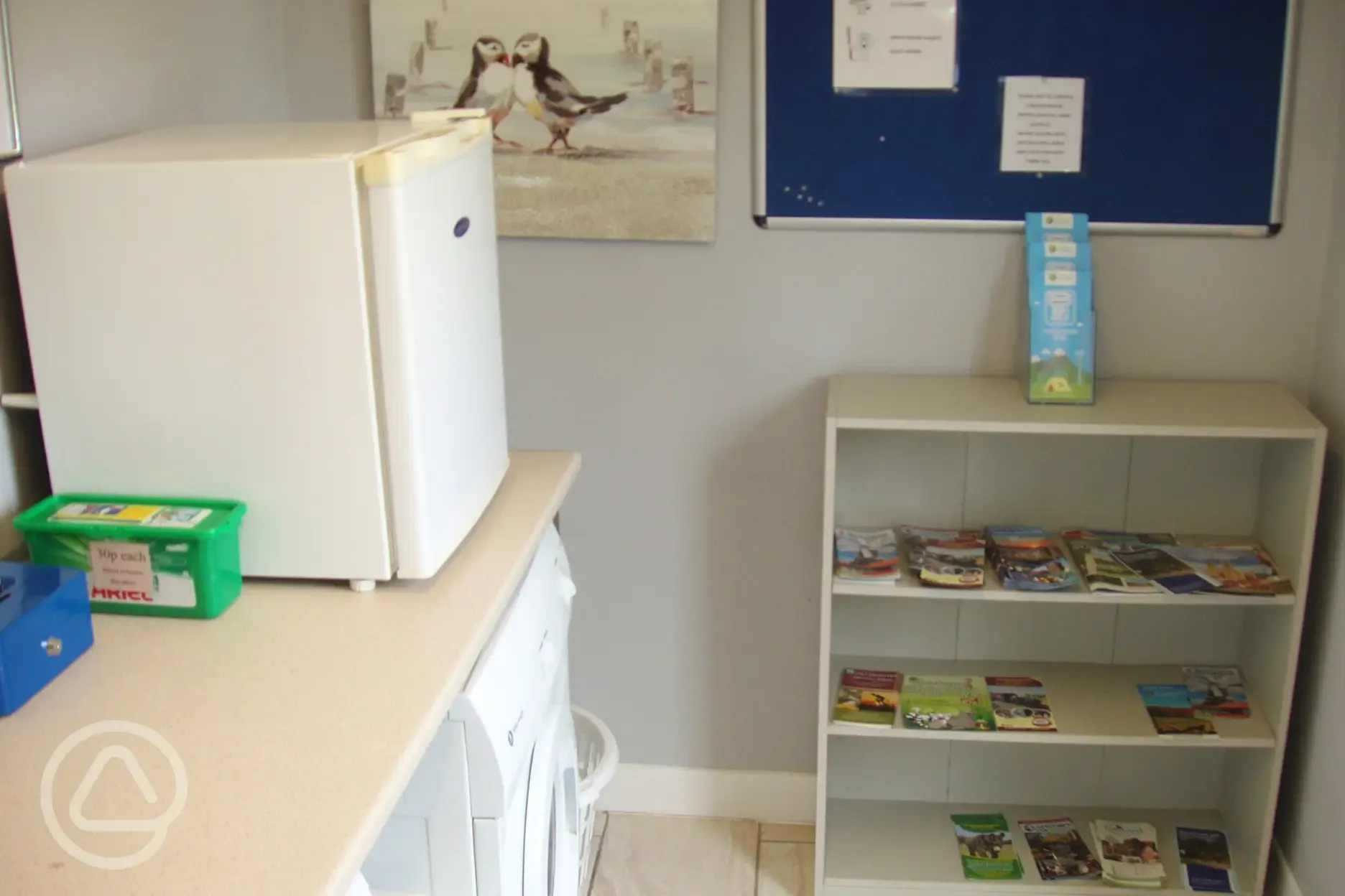 Laundry room with local tourist information and a freezer for ice packs