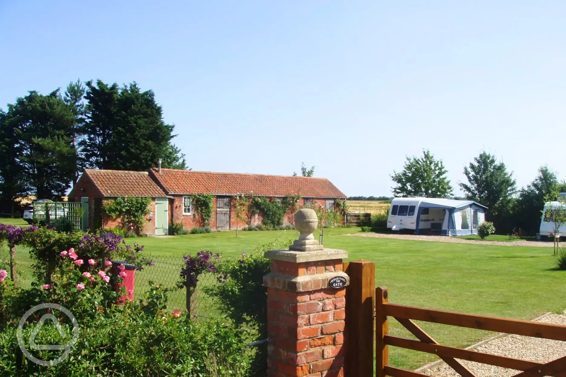 View over the gate of the electric hardstanding pitches and facility block