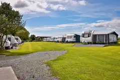 Electric hardstanding pitches with caravans and awnings