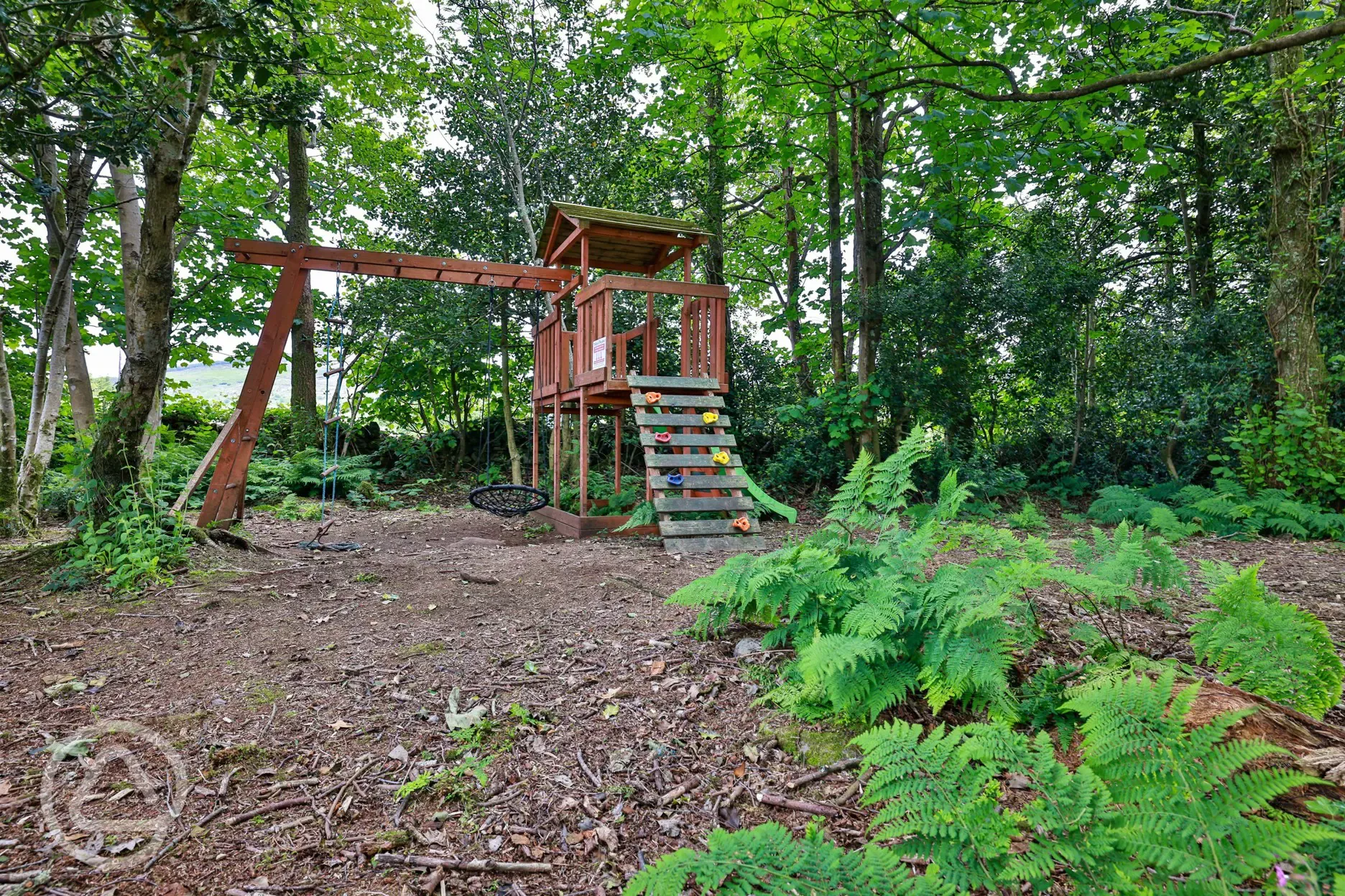 Children's play area with climbing frame and slide