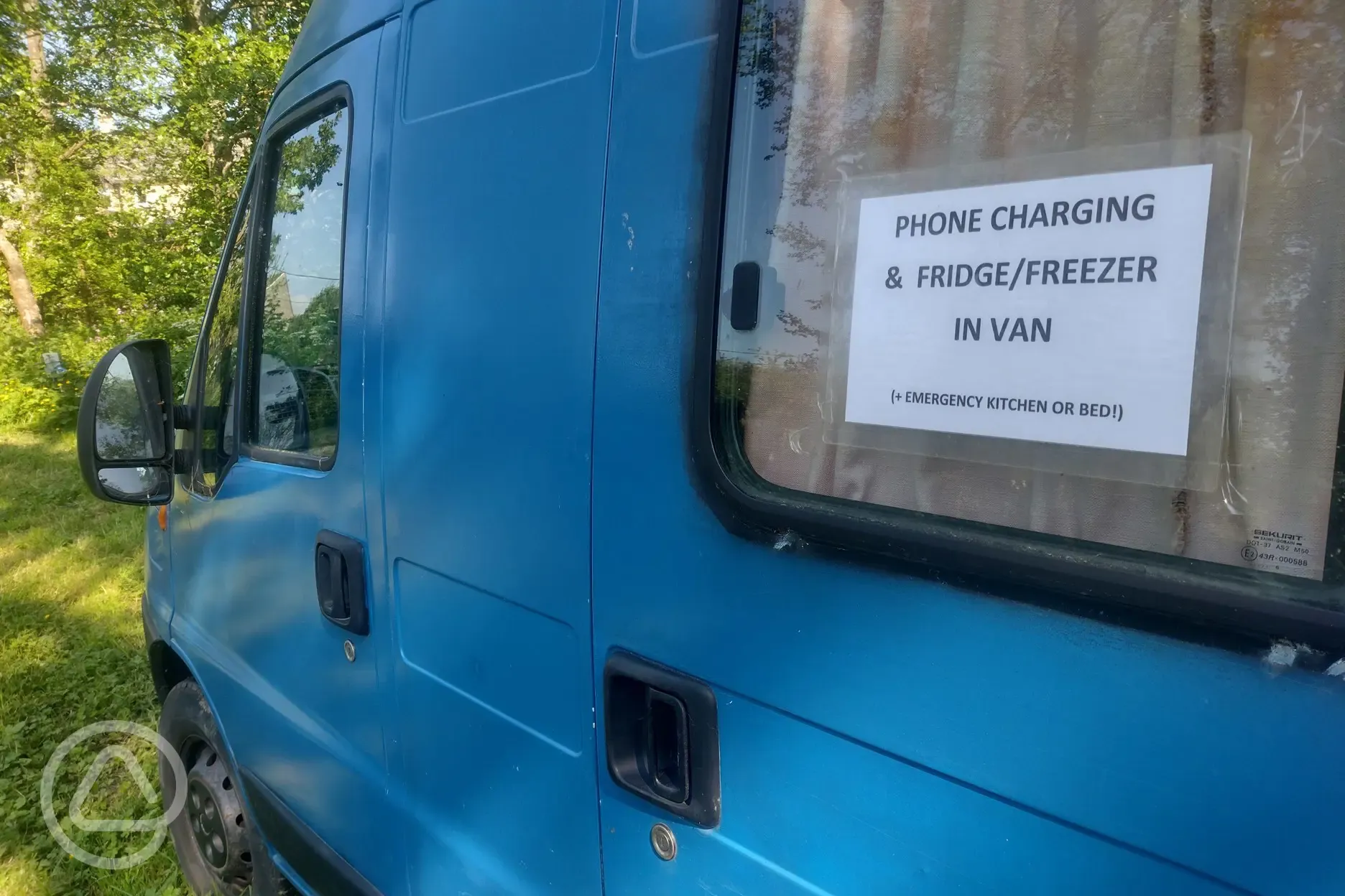 communal fridge, freezer and phone charging point in van