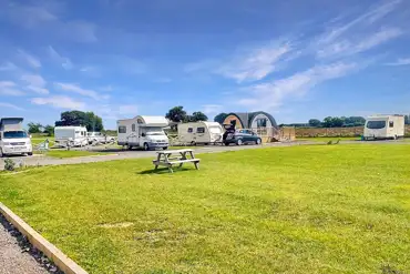Electric hardstanding and grass pitches