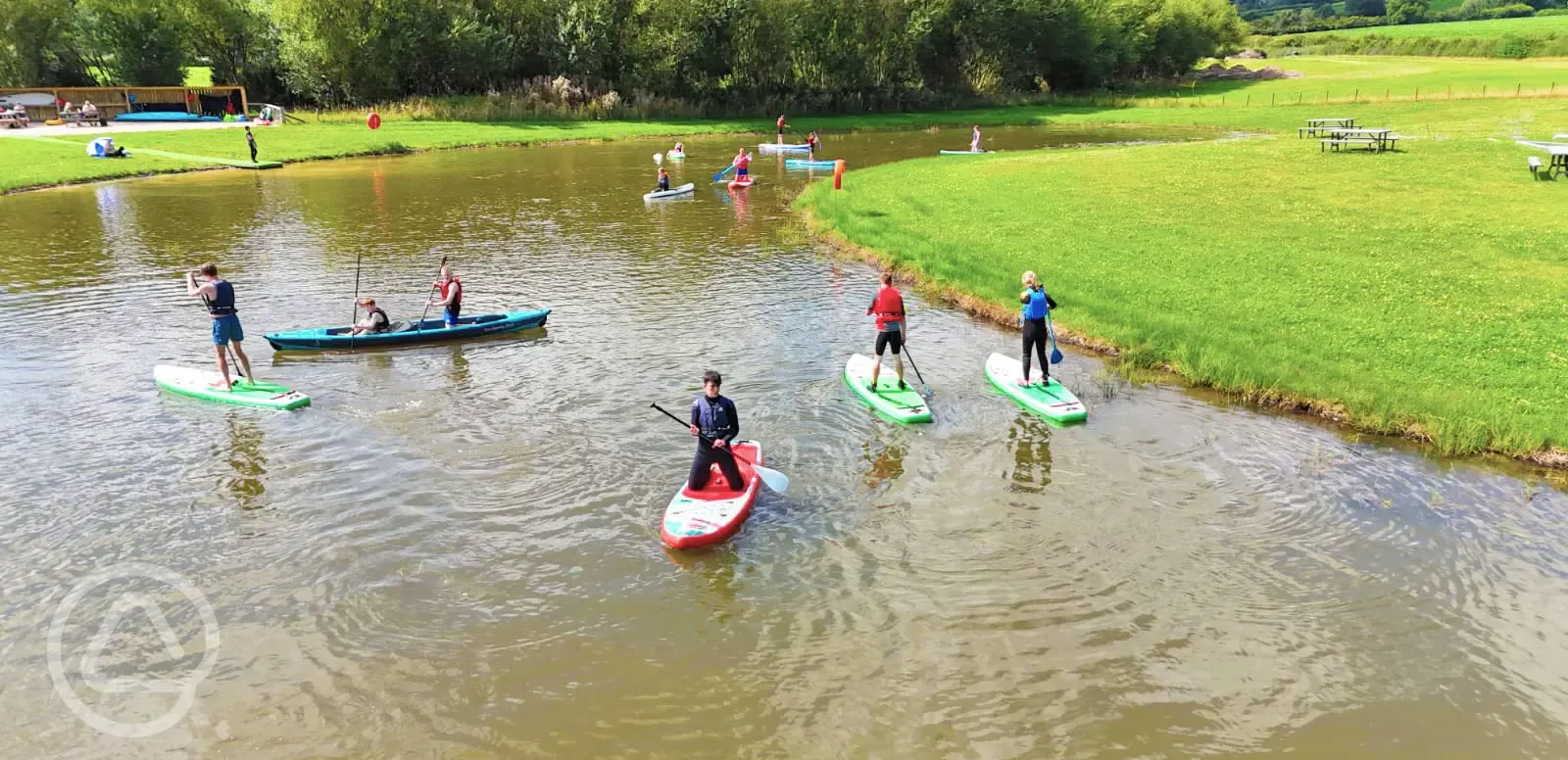 Onsite water sports lake with paddle boarding, kayaking and wild water swimming