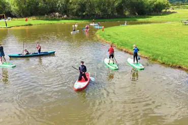 Onsite water sports lake with paddle boarding, kayaking and wild water swimming