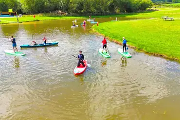 Onsite water sports lake with paddle boarding, kayaking and wild water swimming