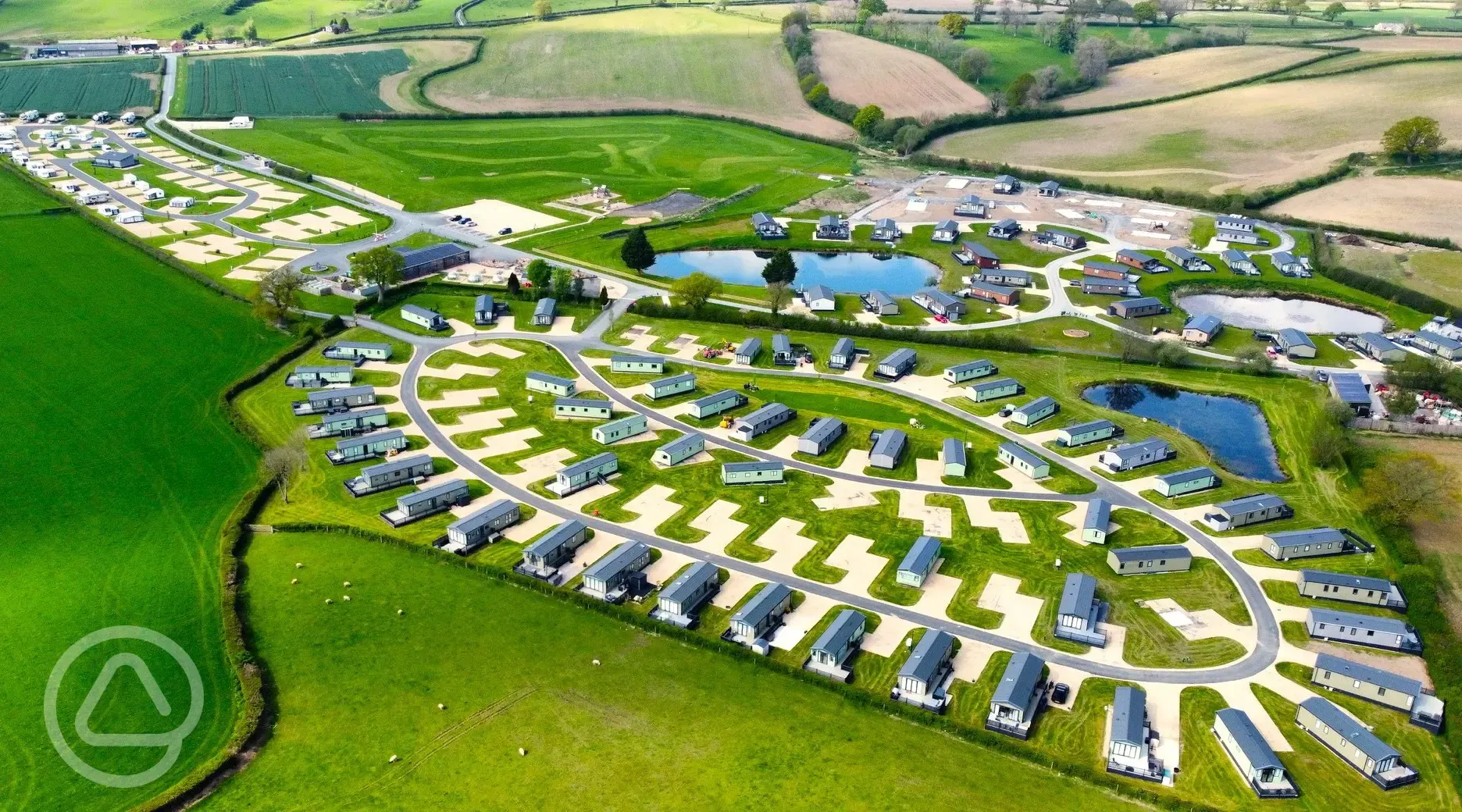 Aerial of the static caravans, touring pitches and the lakes