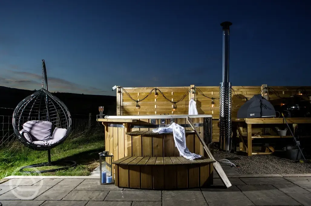 White Clover ensuite pod wood-fired hot tub with fairy lights at night