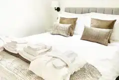 White Clover ensuite pod king size bed with towels, robes, and slippers provided White Clover ensuite pod king size bed with towels, robes, and slippers provided