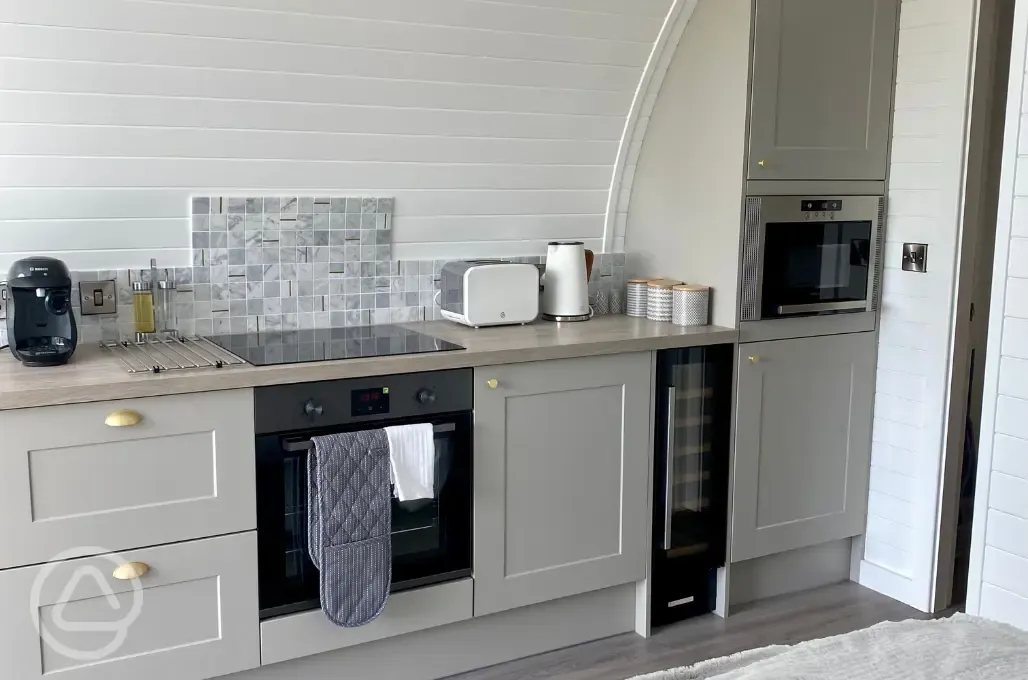 White Clover ensuite pod kitchen area with oven, microwave, toaster, and kettle