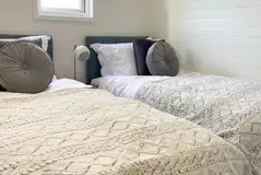 White Clover ensuite pod twin beds in a separate room (bedding provided) White Clover ensuite pod twin beds in a separate room (bedding provided)