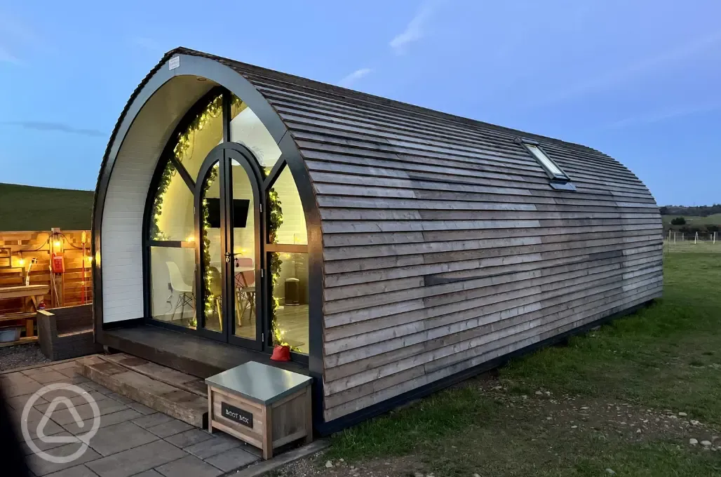 White Clover pod at night with outdoor lighting