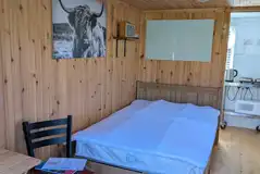 Shepherd's hut double bed and dining area